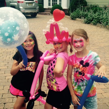 Face painting and balloon twisting for a girls