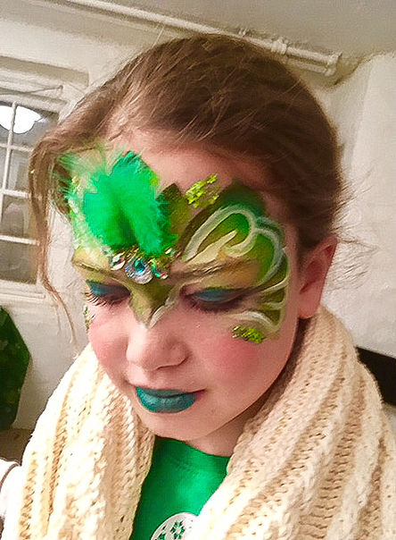 Fancy green Mask face painting with sequins and plumage